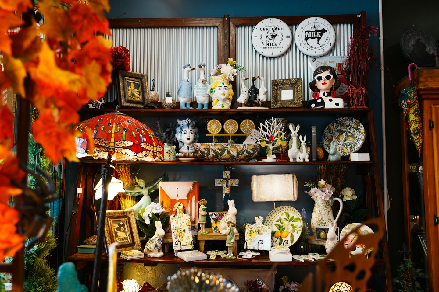 Decorative home goods and gifts displayed on dark wooden shelves.