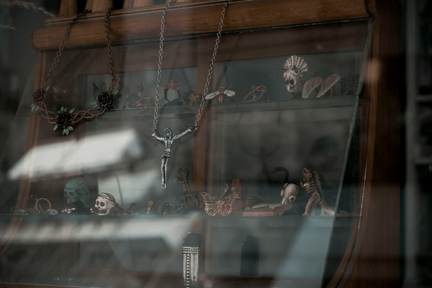 Gothic jewelry and curiosities in a wooden cabinet.